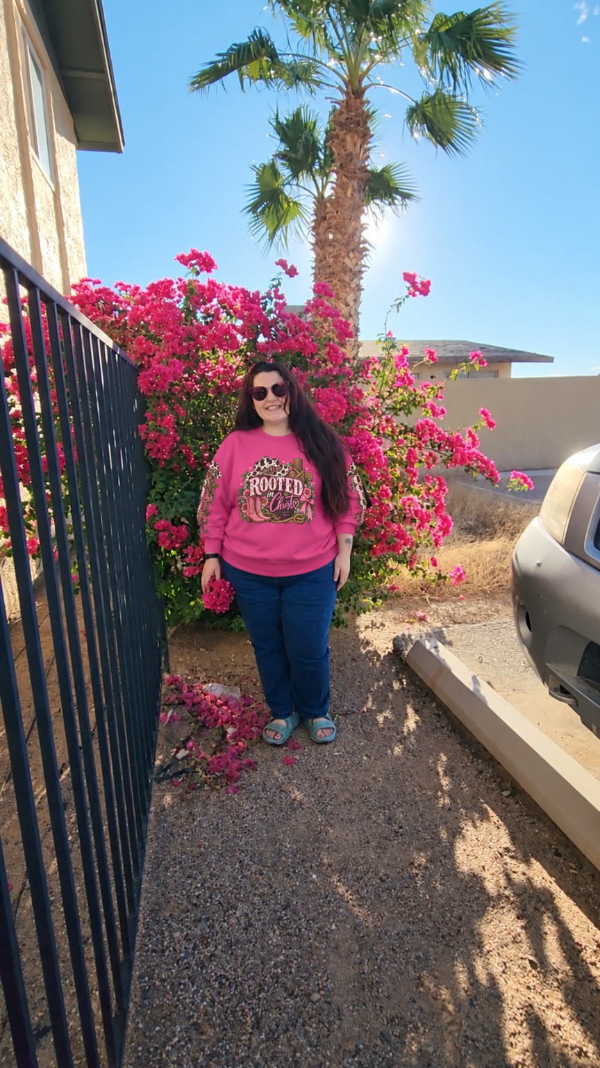 Destinie wearing the pink Rooted in Christ sweatshirt
